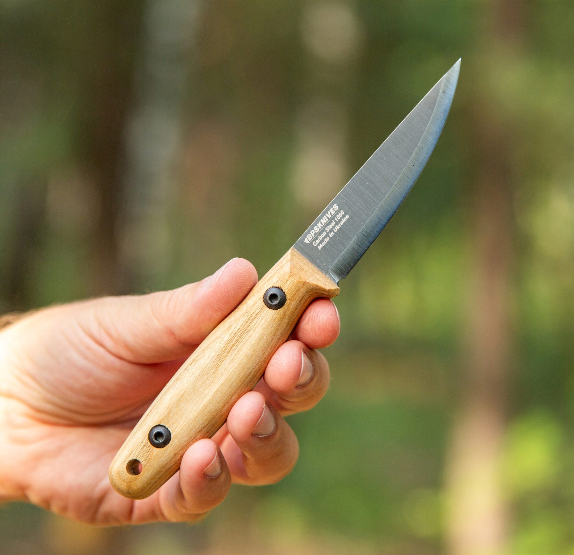 Camping Knife with wooden handle in hand